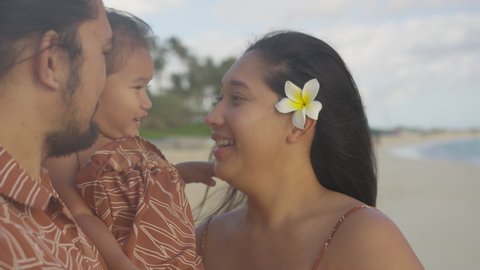 Young Mother and Daughter Embrace at the Beach at Golden Hour Video stock