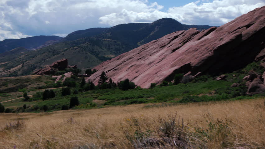 Panning shot of red sandstone monoliths at Red Rocks park and amphitheatre Morrison, Colorado