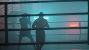 Boxer in the boxing gym. Bandages his hands. Sparring in the ring. Boxer jumping rope. Exercise with ropes. Round one. Fog in the ring. Zetsky sport. Beautiful backlight. World boxing champion.

 - Powered by Shutterstock - Get 15% off with code: PIKWIZARD15