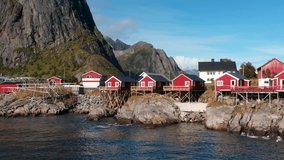 Aerial drone view of Hamnoy in Lofoten islands in Norway on a sunny day. Fjords and mountains at sunset