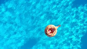 Couple having fun in the pool, the man dives and the woman lies on a donut - Powered by Shutterstock - Get 15% off with code: PIKWIZARD15