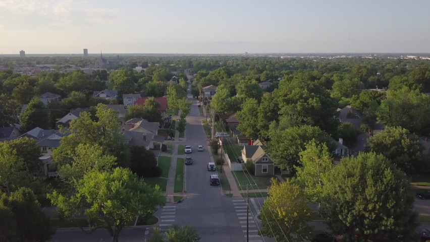 Residential neighborhood in Tulsa, Oklahoma, USA. Drone backwards.  Royalty-Free Stock Footage #1095753757