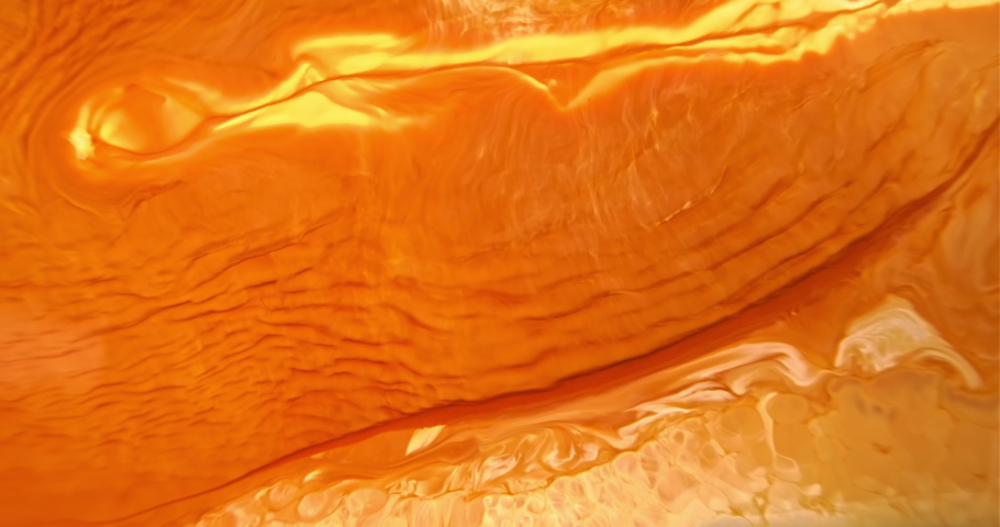 Bright orange paint abstract background. Orange-yellow ink wave flow. Flowing liquid. Bright color art. Fluid backdrop. Acrylic move pattern texture. Beautiful artwork in slow motion. 4k footage