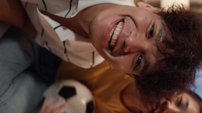 Asia couple sit on sofa excited cheer watch football game video call online show off high score to friend at home. Young couple sport fans happy in front of camera celebrate winner. Vertical Screen. - Powered by Shutterstock - Get 15% off with code: PIKWIZARD15