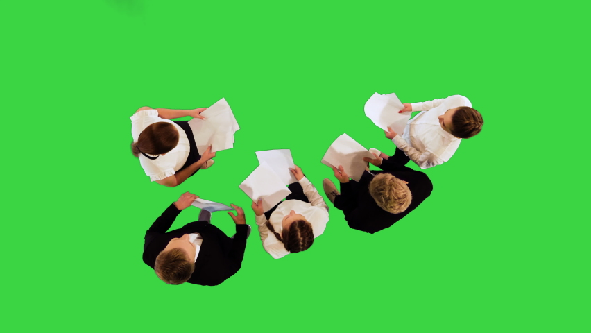 Young associates with papers in their hands on a Green Screen, Chroma Key. | Shutterstock HD Video #1095766459
