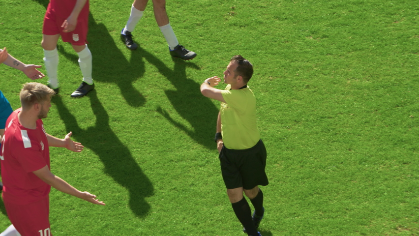 Soccer Football Championship Match: Referee Sees Foul, Gives Signal and Yellow Card, Players Circle him Upset. International Tournament. Sport Broadcast Channel Television Playback. Slow Motion Royalty-Free Stock Footage #1095767455