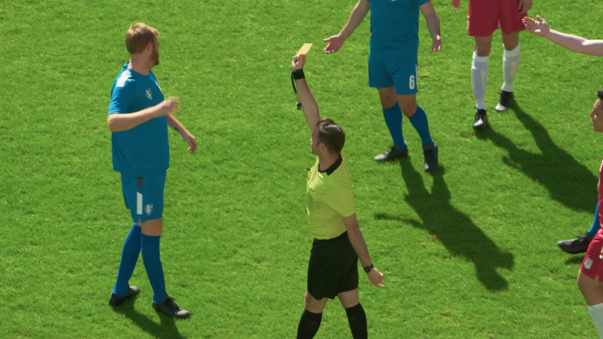 Soccer Football Championship Match: Referee Sees Foul, Gives Signal and Yellow Card, Players Circle him Upset. International Tournament. Sport Broadcast Channel Television Playback. Slow Motion