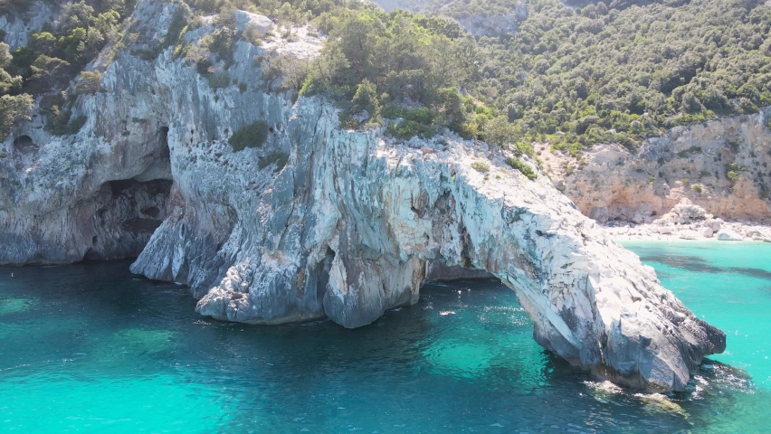 Aerial view of the famous Cala Goloritze in Orosei Gulf, East Sardinia, Italy. Drone and birds eye of clear and crystalline water over the top of Punta Salinas, Sardinia (Sardegna drone). 
