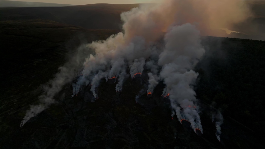 Heather burning on moorland above Holmfirth in West Yorkshire, long history of use in managing moorland.  Royalty-Free Stock Footage #1095770809