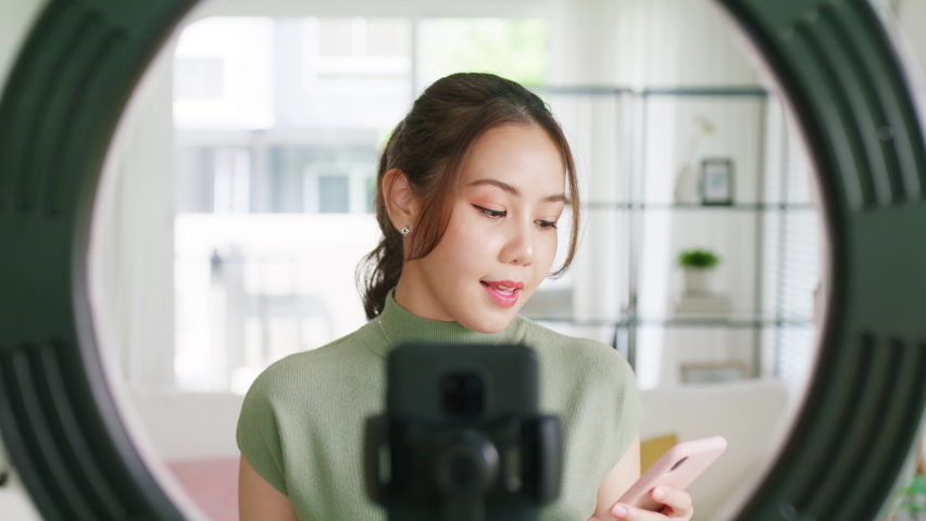 Beauty blogger Gen Z talk chat to IG instagram tiktok camera in influencer youtuber asia people adult woman. Vlogger young girl happy blog vlog page shop live read reply fan hit like love emoji icon. | Shutterstock HD Video #1095782133