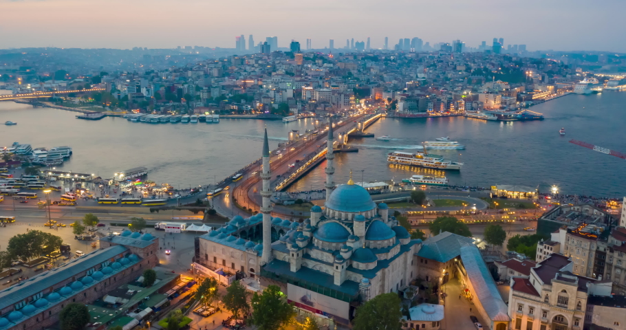 Drone Hyperlapse of Galata Bridge at sunset. Traffic lights of cars, ferry boats and ships sailing, evening city lights. Istanbul, Turkey, aerial timelapse, transportation