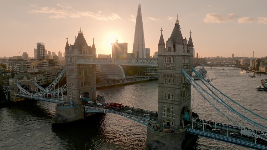 Iconic Tower Bridge at sunset. Connecting London with Southwark on the Thames River. Aerial sunset view of London city center and the Tower bridge of London.  Royalty-Free Stock Footage #1095796769