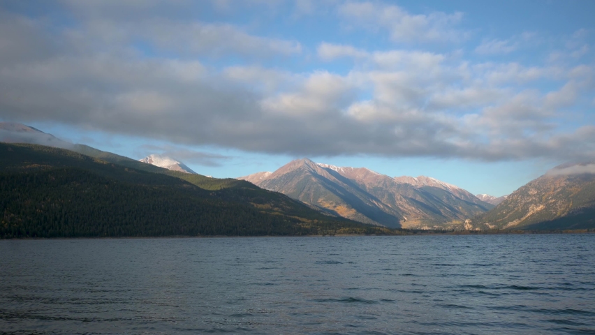 Low clouds over the Rocky Mountains with Twin Lakes Reservoir in front during the day, static