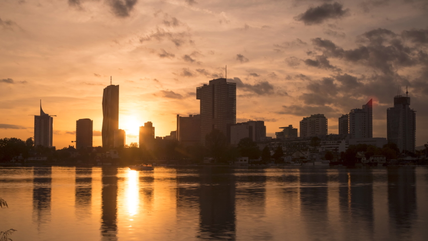 Vienna skyline view at sunset, austria vienna skyscrapers timelapse footage view of river in 4k.