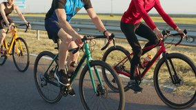 Close up of sporty men and woman using professional bikes for outdoors riding. Three caucasian people in activewear enjoying favorite hobby on fresh air. Workout and cycling concept. - Powered by Shutterstock - Get 15% off with code: PIKWIZARD15