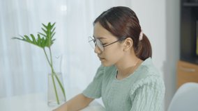 Asian woman feeling stress from work in the office.Tired business woman at workplace in office holding her head on hands feel headache.