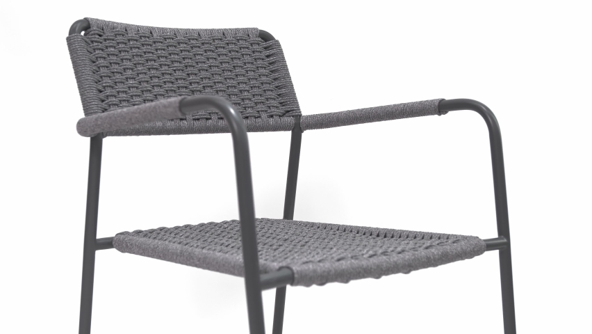 Contemporary gray rope and aluminum frame chair for outdoor use. White background. Isolated | Shutterstock HD Video #1095814093