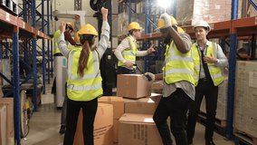 Group of happy diverse warehouse workers dancing together in warehouse, Skillful warehouse workers celebrating success in store factory, Industrial people and manufacturing labor concept - Powered by Shutterstock - Get 15% off with code: PIKWIZARD15