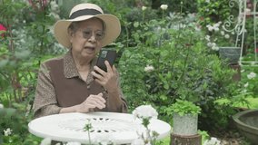 asian old elderly senior elder woman talking using video chat on smart mobile phone