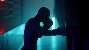 Boxer in the boxing gym. Bandages his hands. Sparring in the ring. Boxer jumping rope. Exercise with ropes. Round one. Fog in the ring. Zetsky sport. Beautiful backlight. World boxing champion. - Powered by Shutterstock - Get 15% off with code: PIKWIZARD15
