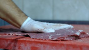 Chef cuts raw meat with knife videos, close-up view of master chef cutting steak with knife, chopping meat, master chopping steak, veal on red background