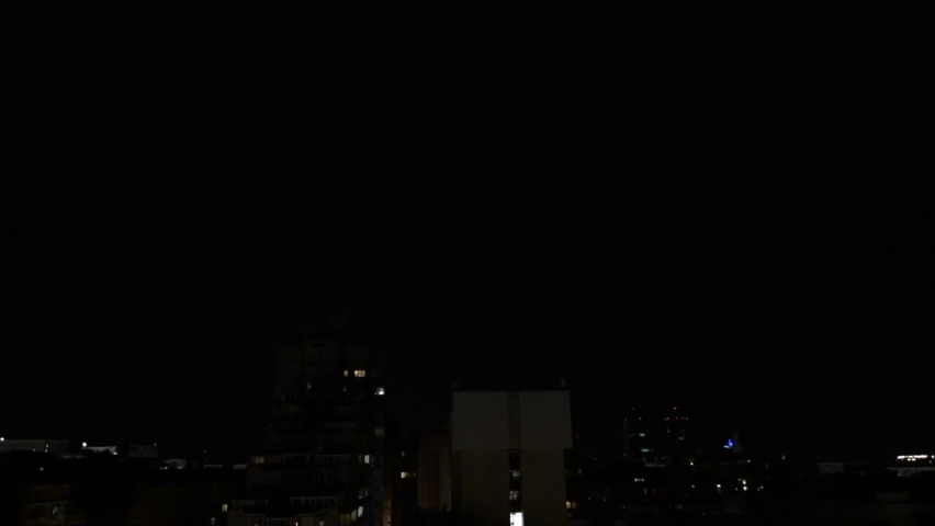 Lightning and thunder over the city at night, glaring and spectacular lightning, thunderstorms from window in near vintage skyscraper