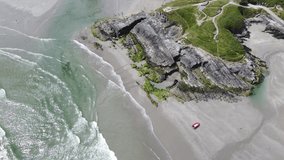 Cape of the Virgin Mary on the coast of Ireland in County Cork. Atlantic Ocean waves and coastal rock, drone video. Picturesque seascape, waves.