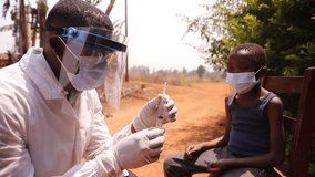 An African doctor prepares a syringe to inject the vaccine to a child. Vaccination concept in Africa	
 - Powered by Shutterstock - Get 15% off with code: PIKWIZARD15