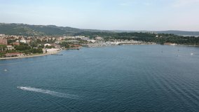 Portoroz beach Slovenia Aerial Footage on the Adriatic Seaside with Venetian Architecture. 4K Drone Footage of City Town St. George's Parish Church, Tartini Square and Harbour Hotels beach view