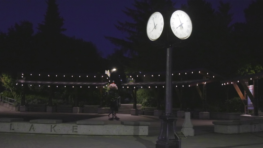 Historical Clock in Harrison Lake Plaza during night after summer sunset. Tourist Attraction in British Columbia, Canada. Slow Motion cinematic
