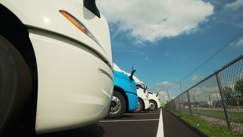 Many Trucks stand in the parking lot. Close up shot. move camera