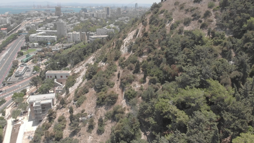 The slope of Mount Carmel with a building over the cave of Elijah the Prophet. The Bat Galim area and the Mediterranean Sea in the background. Haifa, Israel. Drone video footage.