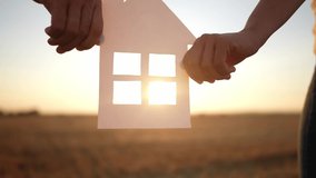 paper house happy family. friendly family hands holding paper house the glare of the sun shine through the window a beautiful sunset. mortgage lifestyle business construction concept. house dreams - Powered by Shutterstock - Get 15% off with code: PIKWIZARD15