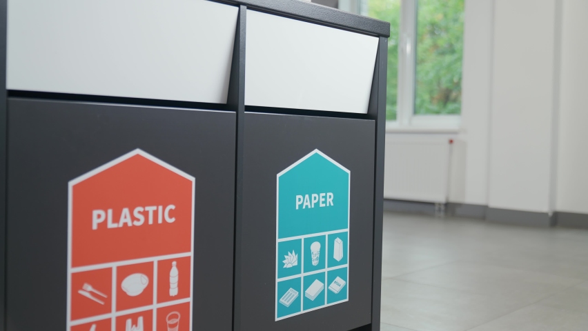 Waste recycle, separate garbage disposal, an office worker throws cardboard into container for paper waste and plastic into container for a plastic, ecology of the planet. Royalty-Free Stock Footage #1095843745