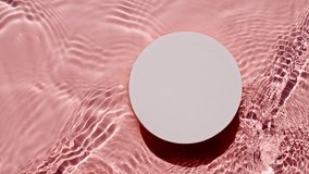 Empty white circle podium on transparent clear water texture with waves in sunlight. Slow motion of waves water on pink background. Sun and shadows. Video for design, advertising, products