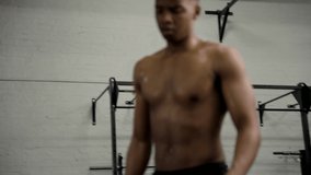 Shirtless muscular young black man using mobile phone between workout at the gym. 3D Illustration