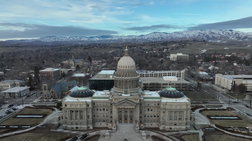 Main Facade Of Idaho State Capitol In Boise, Idaho, USA. Mountain Landscape In Distant Background. aerial