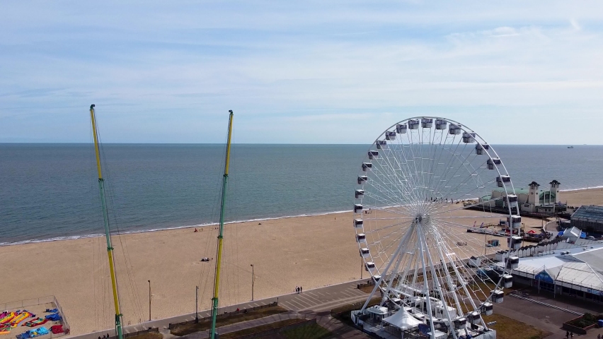 Amusement park with Ferris wheel and sea beach in Great Yarmouth, Norfolk, England - aerial drone shot Royalty-Free Stock Footage #1095848999
