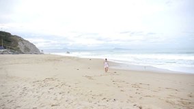Woman running on a sandy beach