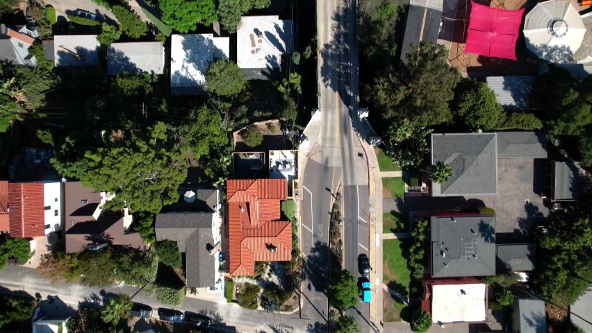 Looking down over Shakespeare bridge, Franklin hills palm tree streets in Los Angeles, California aerial view