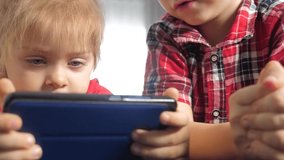 children watch online video cartoons on lifestyle a smartphone. kids little boy and girl brother sister watch online streaming broadcasting on the phone - Powered by Shutterstock - Get 15% off with code: PIKWIZARD15