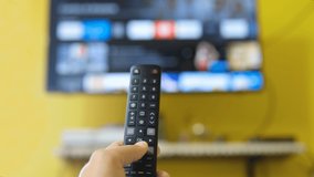 Man browse smart tv application,zapping channels on leisure lockdown time,home lifestyle