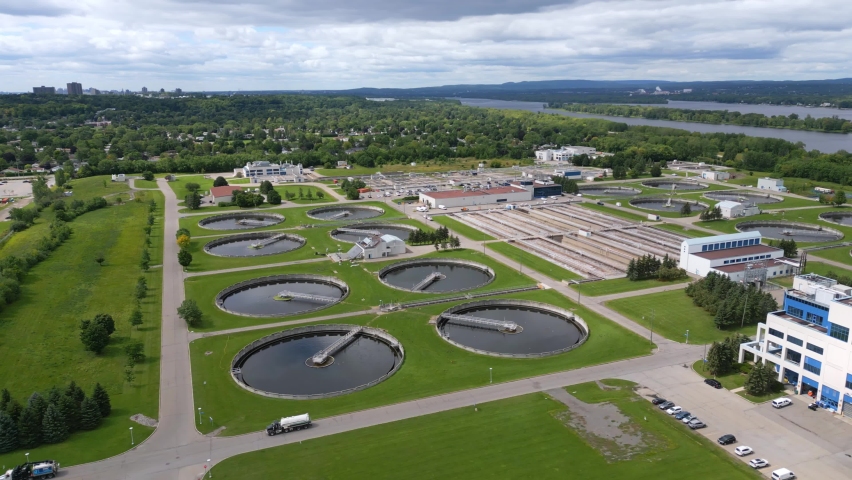 Canadian wastewater sewage plant next to Ottawa River on a cloudy summer day