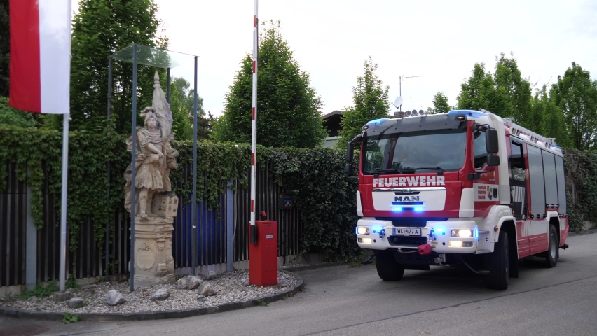 Thalheim bei Wels - April 30 2020: Fire truck with warning lights turned on parked outside of fire station