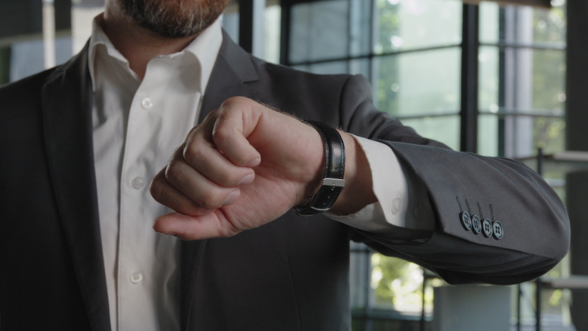Close up male hand with luxury watch 40s bearded man businessman entrepreneur HR manager looking at wristwatch checking time minutes smile toothy happy smiling enjoy punctuality glad waiting meeting Royalty-Free Stock Footage #1095873763