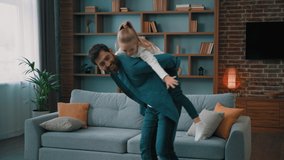 Active father piggyback carrying on back little toddler girl daughter caucasian healthy family playing in child airplane game happy kid flying enjoying holidays laughing having fun together at home - Powered by Shutterstock - Get 15% off with code: PIKWIZARD15