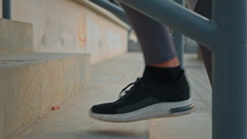 Close up female athletic legs sportswoman motivated runner jogger in sneakers climb stairs on stadium cardio exercise fitness step slowly run active woman dynamic go staircase sport activity outdoors Royalty-Free Stock Footage #1095873813