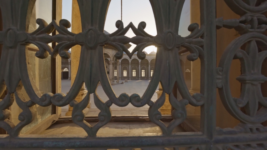 Great Mosque of Muhammad Ali Pasha or Alabaster Mosque in Cairo, Egypt. Sun breaks through lattice of window in the mosque Muhammad Ali Pasha, courtyard is visible inside. Citadel of Cairo. Gimbal
