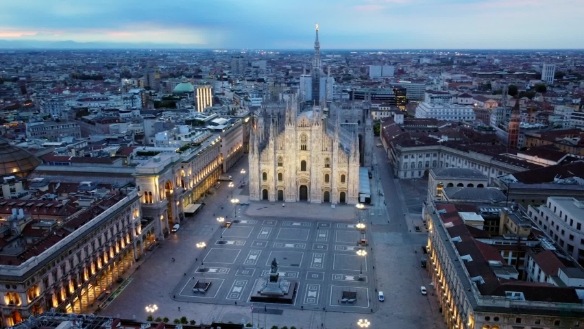 Aerial view of the statue of the Madonna on the central spire of the duomo and the city