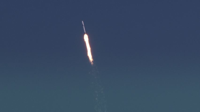 Powerful Rocket flies into space in a blue sky with nice clouds. Slow motion. Includes audio.